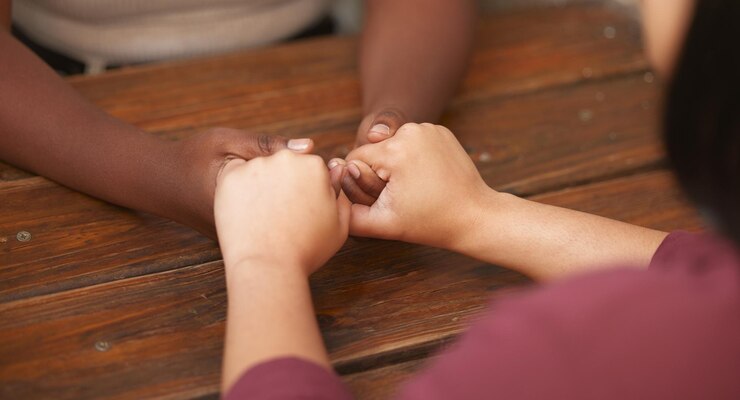 Fotografie support trust and diversity women holding hands for help with emotional problem mental health crisis or depression lgbtq bond lesbian love and black woman or couple helping with anxiety together