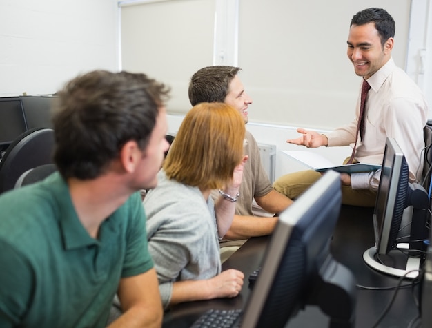teacher and mature students in computer room