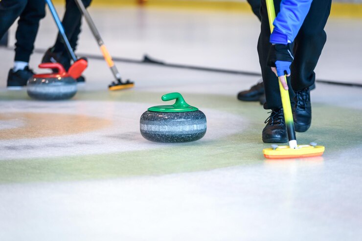 Fotografie team members play in curling at the championship