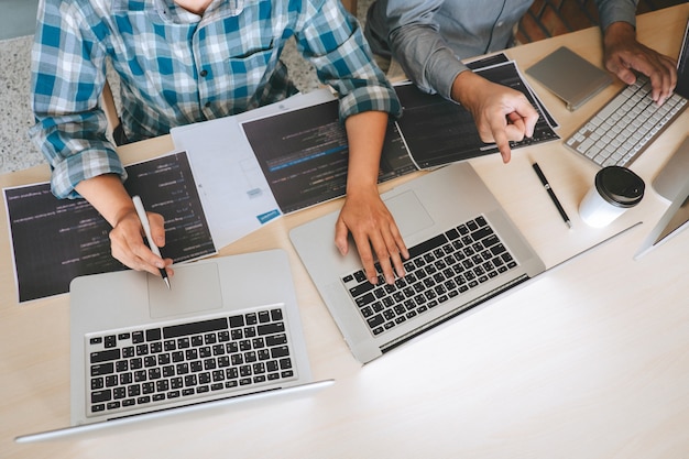 Team of Professional Developer programmer cooperation meeting and brainstorming and programming in website working a software and coding technology, writing codes and database