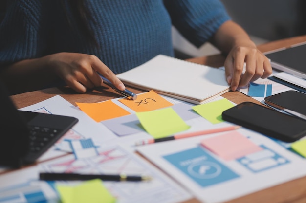 the designer team is designing the uxui system to make the uxui system work well on new phones and support system updates website development concept ui ux front end designer