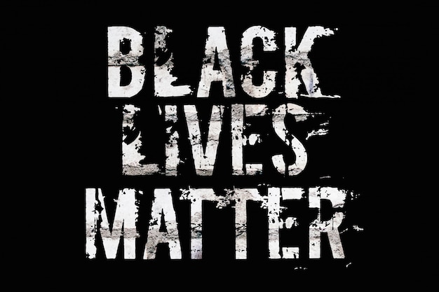 The inscription black lives matter on the brick wall