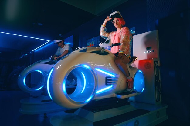The player plays motorcycle racing in vr a young woman with pink hair plays games high quality photo