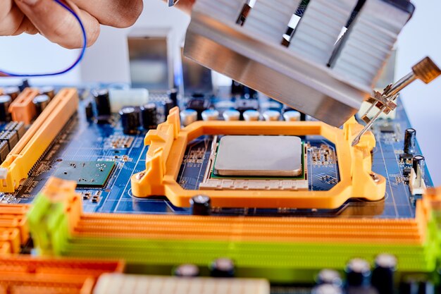 The technician is putting the CPU on the socket of the motherboard