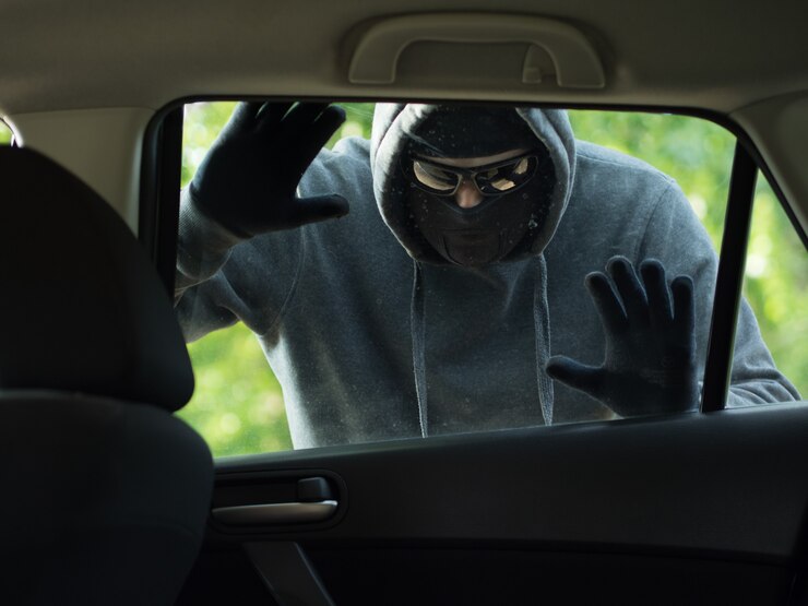 Fotografie transportation crime concept thief stealing bag from the car