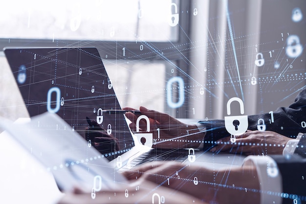 Two business people working on the project to protect cyber security of international company using laptop Padlock Hologram icons Teamwork concept