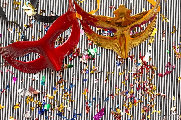 two colorful carnival masks on the colorful background with several ornaments