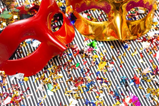 two colorful carnival masks on the colorful background with several ornaments