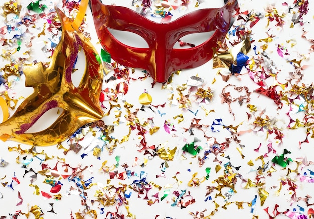 two colorful carnival masks on the white background with several ornaments