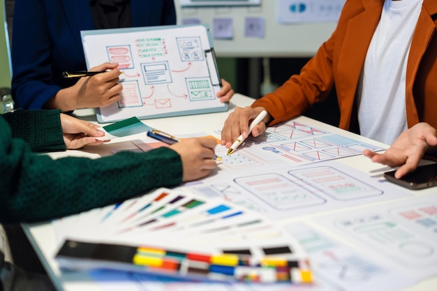 UX developer and ui designer brainstorming about mobile app interface wireframe design with customer breif and color code User experience concept