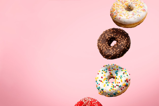 various donuts flying in the air isolated