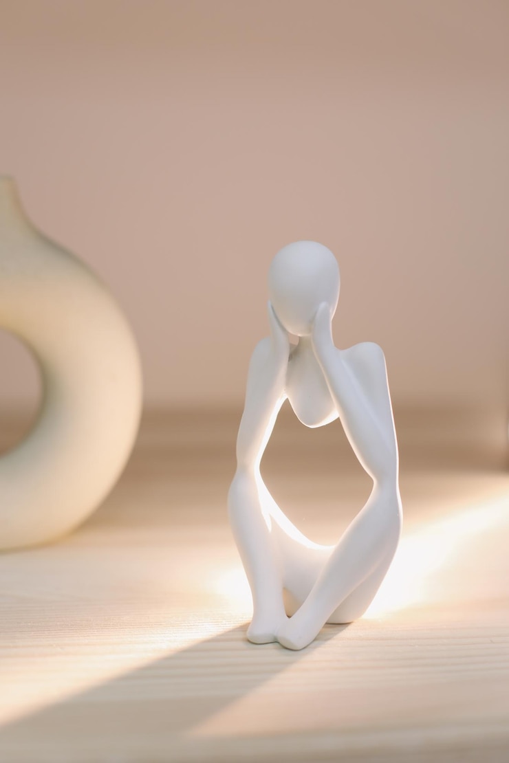 Fotografie white gypsum decorative figure against beige background with copy space concept of template for website or commercial banner