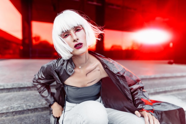 woman in stylish glasses on a red background