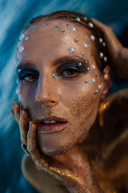 woman portrait in gold glitters