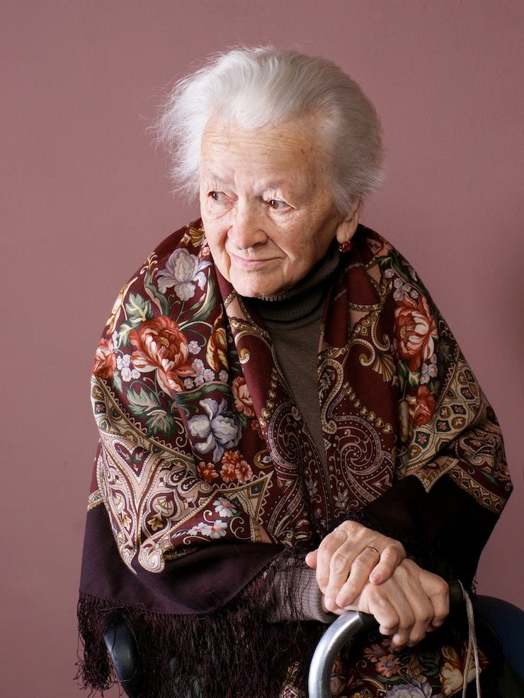 Fotografie woman with a cane isolated on brown