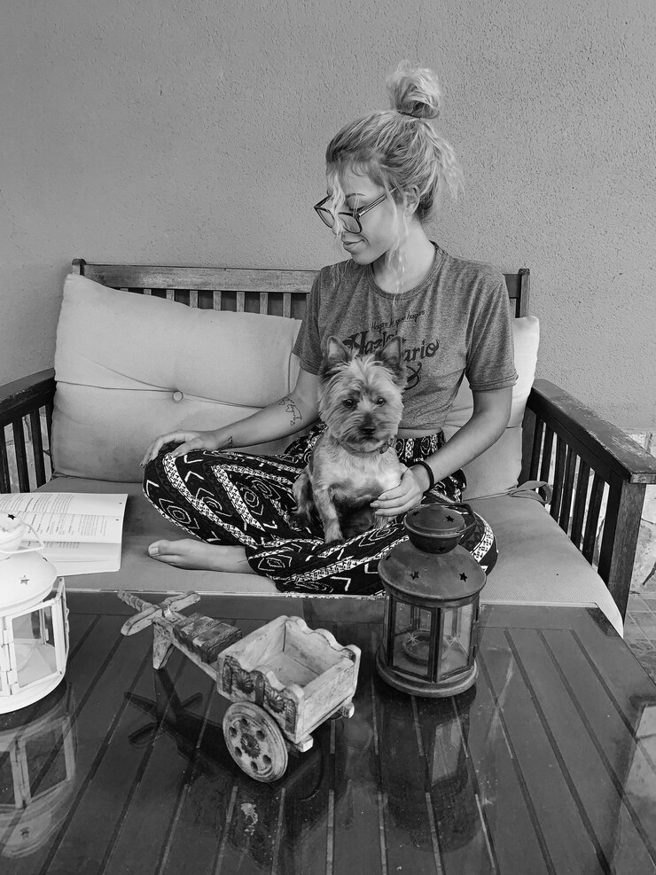 Fotografie woman with dog sitting on sofa at home