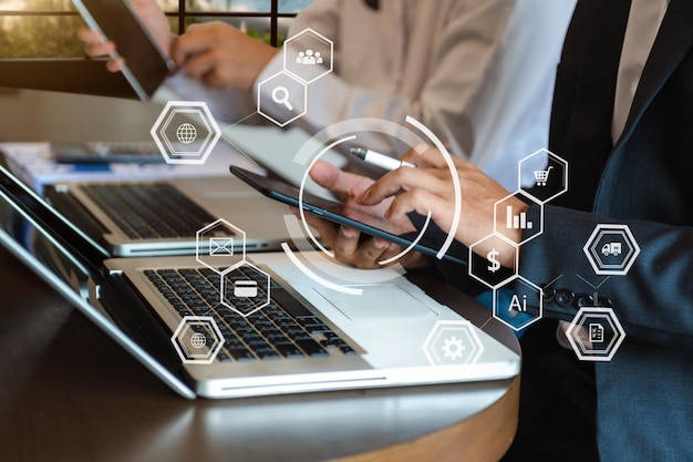 working team meeting concept business using laptop and smart phone and digital tablet computer with digital marketing media in virtual icon network diagram office in morning lightxaxa