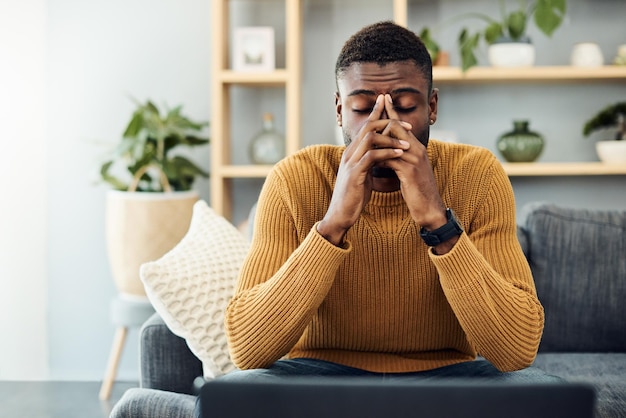 young man sitting on sofa at home