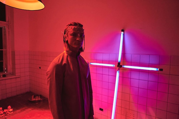 young man standing in illuminated room