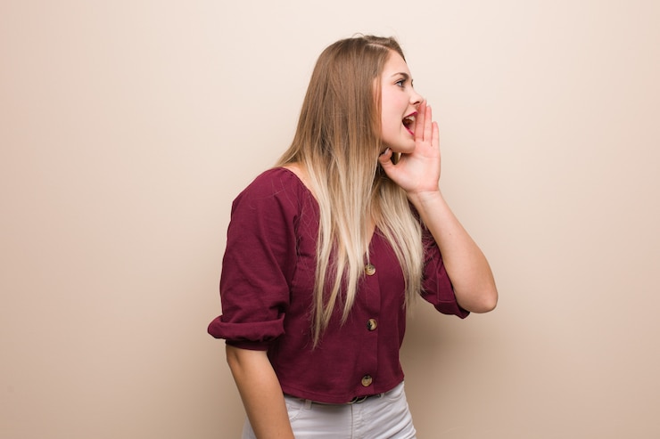 Fotografie young russian woman whispering gossip undertone