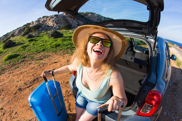 Young woman smiling while sitting in car