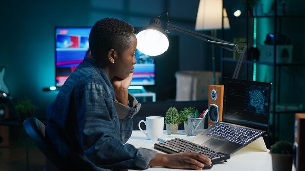 ai expert writes code on laptop in apartment office