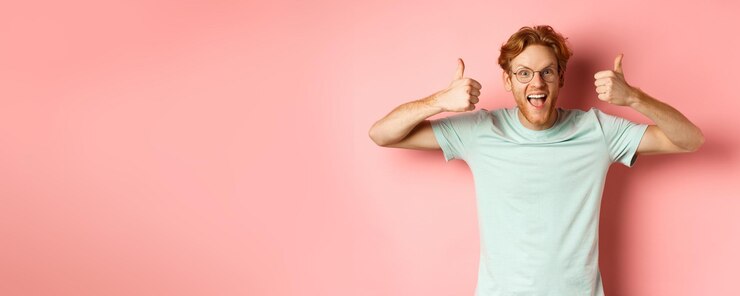 Zdarma Fotografie amazed redhead guy scream with joy and looking impressed and excited showing thumbs up in approval p