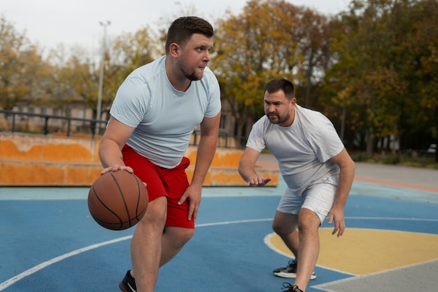authentic scenes of plus-size males playing basketball