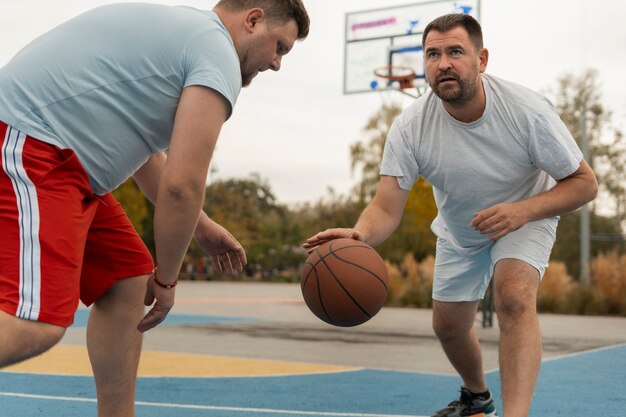 authentic scenes of plus-size males playing basketball