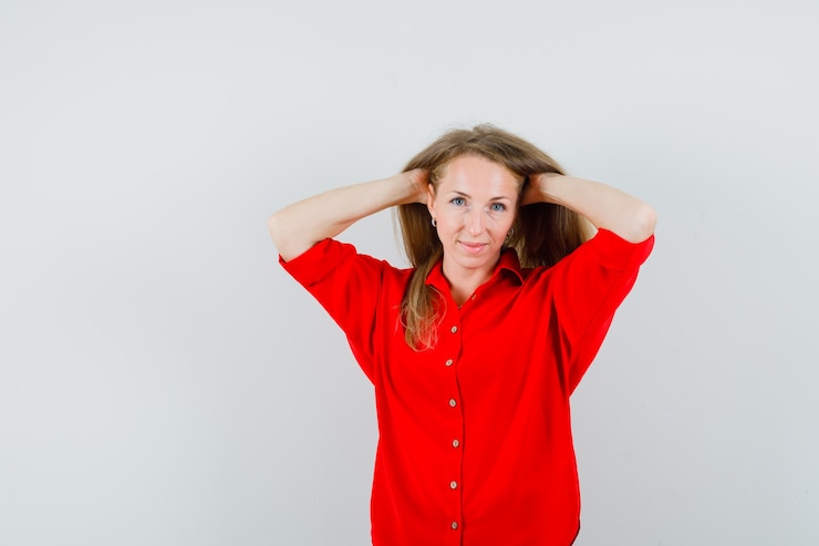 Zdarma Fotografie blonde woman in red shirt posing with hands in hair and looking charming ,