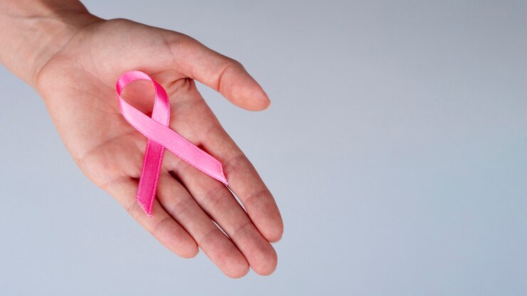 Zdarma Fotografie close-up person holding pink ribbon