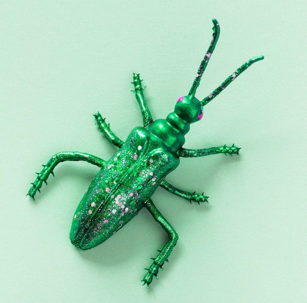 Colorful miniature bug on a paper