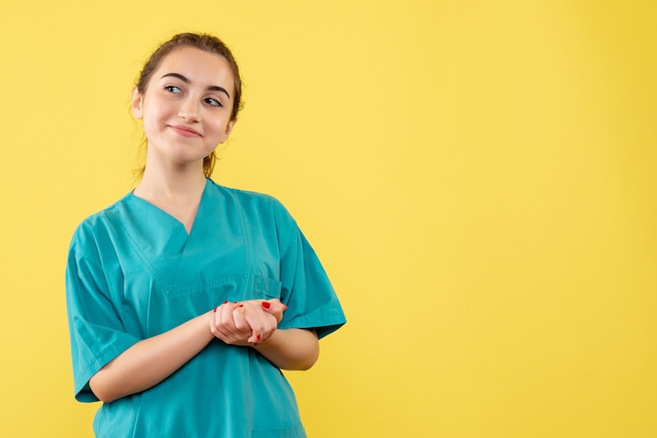 Zdarma Fotografie front view of young female doctor in medical suit on yellow wall