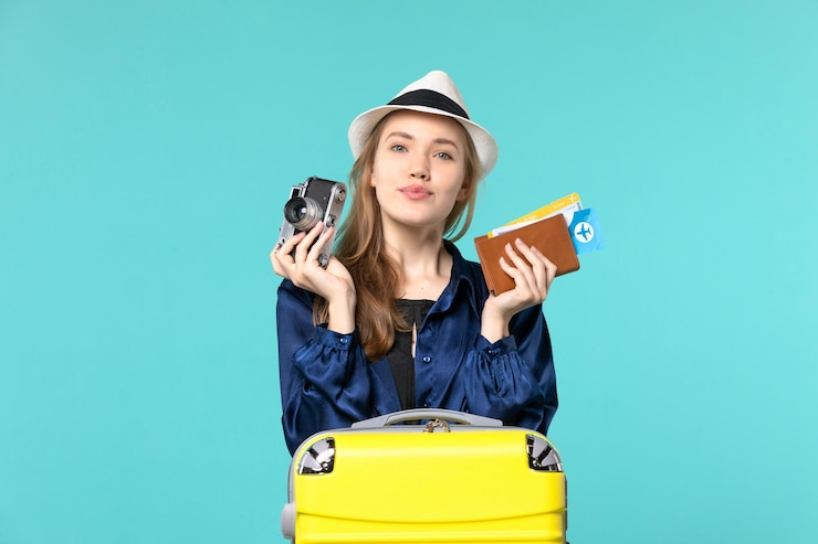 Zdarma Fotografie front view young woman holding camera and tickets on blue background sea travelling journey plane voyage