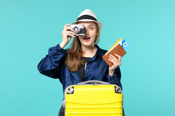 Zdarma Fotografie front view young woman holding camera and tickets on blue background sea travelling journey vacation voyage plane