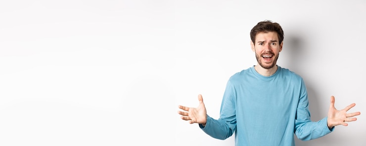 Zdarma Fotografie image of frustrated and worried young man shaking hands trying to explain something standing anxious