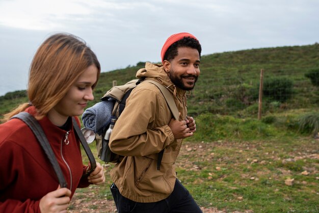 medium shot couple hiking together