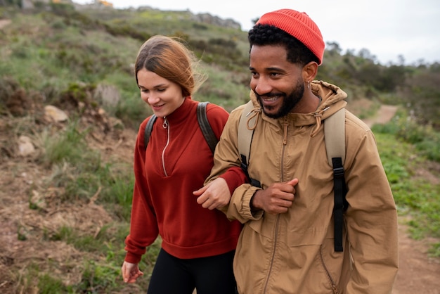 medium shot couple hiking together