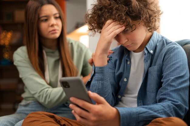 medium shot  sad teenager being cyberbullied