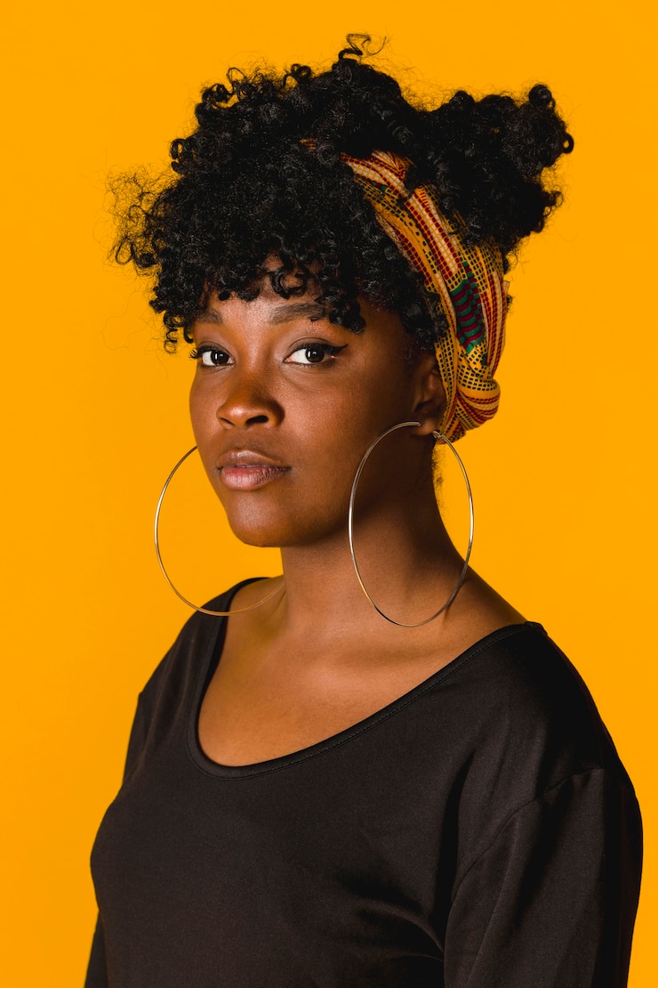Zdarma Fotografie portrait of ethnic curly young woman on colored background