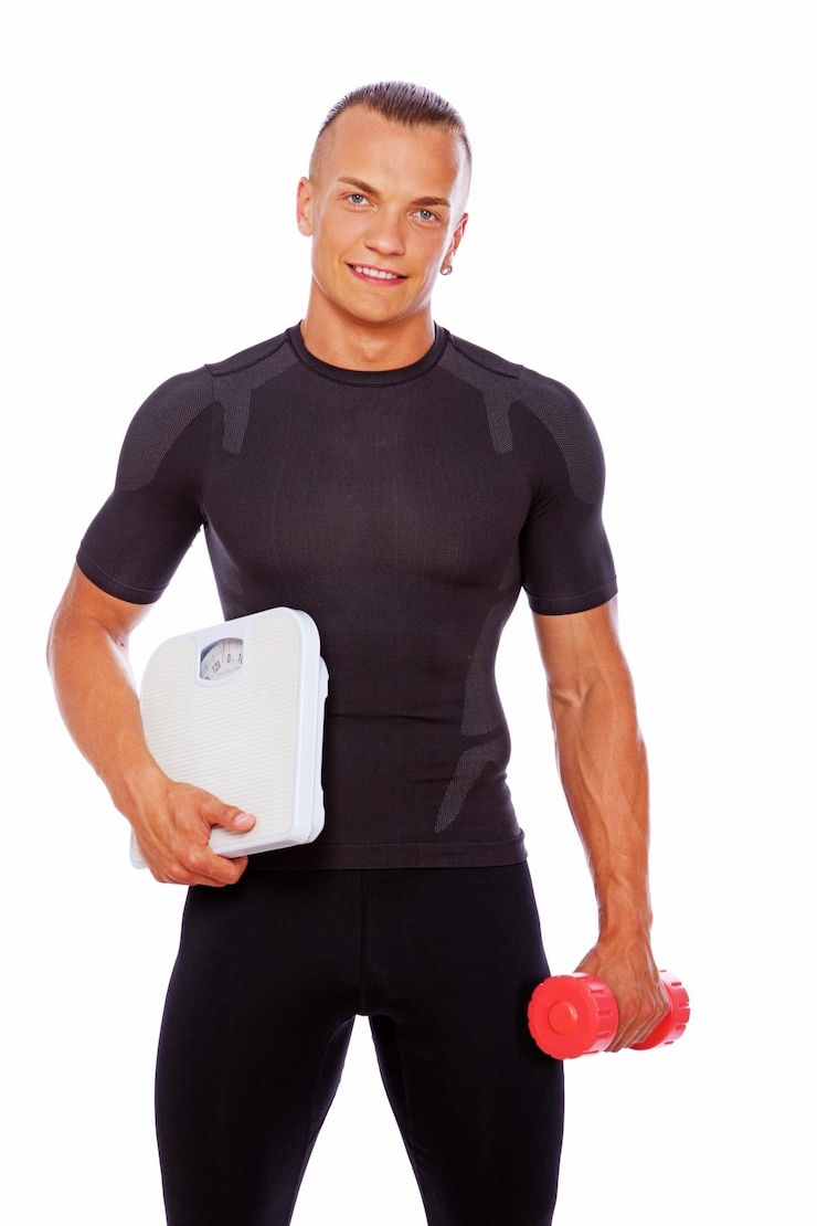 Zdarma Fotografie portrait of sportsman posing in studio with scales