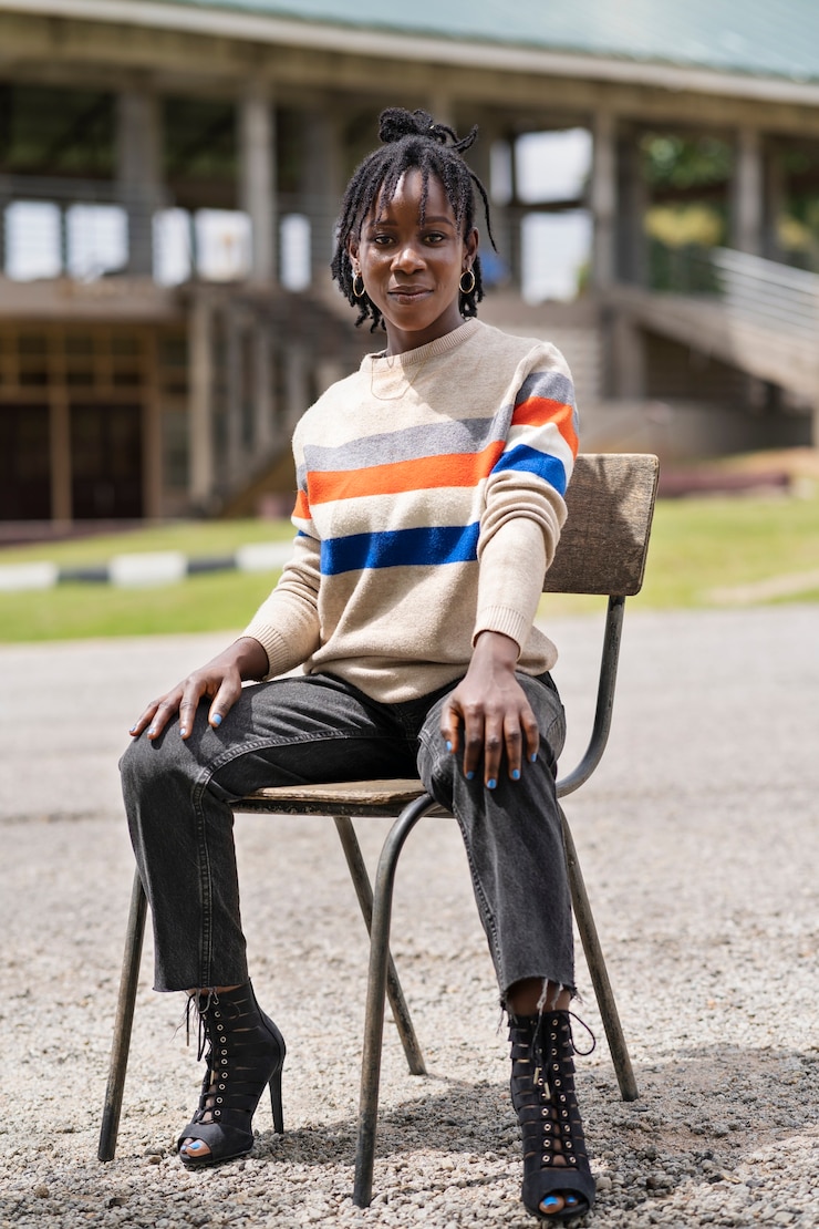 Zdarma Fotografie portrait of young woman with afro dreadlocks sitting on chair outdoors