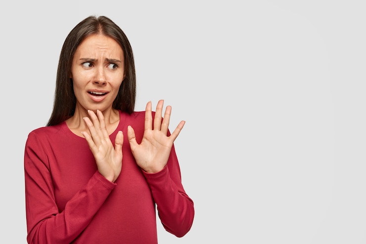 Zdarma Fotografie puzzled anxious woman rejects something unpleasant, keeps palms in no gesture