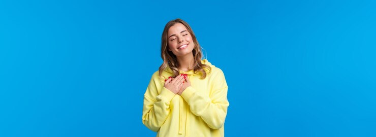 Zdarma Fotografie romantic alluring blond caucasian girlfriend in yellow hoodie press hands to heart and close eyes wi