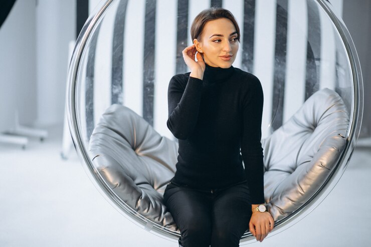 Zdarma Fotografie woman sitting in hanging glass chair