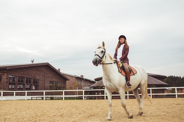 a garota monta um cavalo