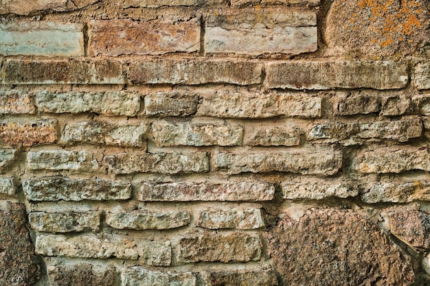 A textura do fundo de pedra de pedra de diferentes pedras e arenito ideia para design de interiores de fachada de casa ou edifício