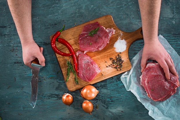Foto grátis açougueiro cortar carne de porco na cozinha