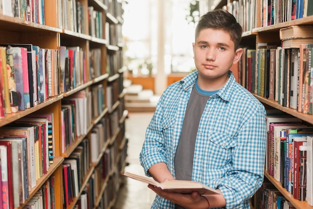 Adolescente, com, livro aberto, olhando câmera