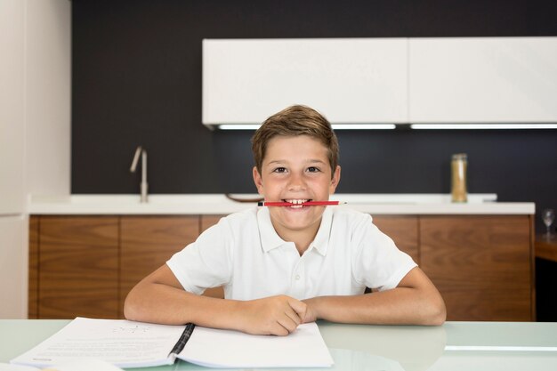 Adorável jovem garoto fazendo sua lição de casa
